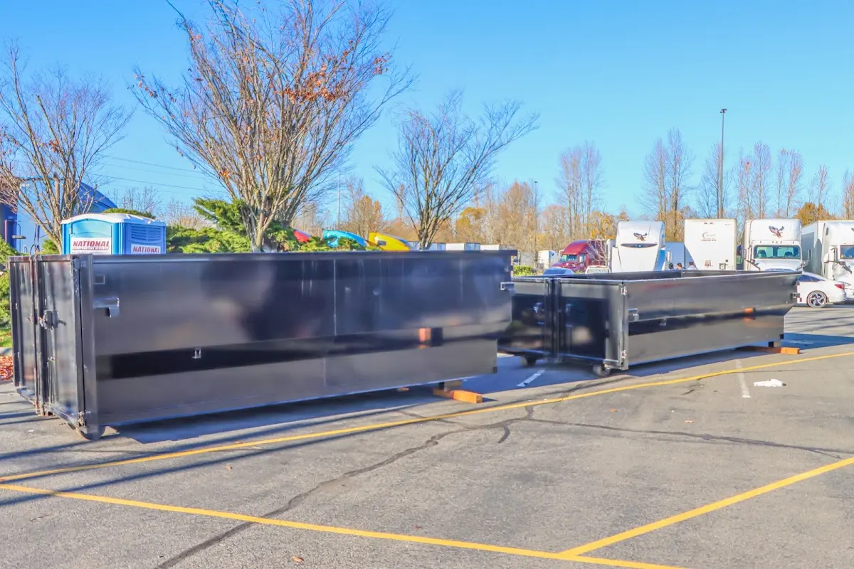 Professional dumpster rental service with roll-off container on residential driveway in Coral Terrace